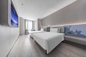 Katil atau katil-katil dalam bilik di Atour Light Hotel Zhuhai Xiangzhou Mingzhu Station