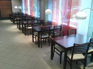 a row of tables and chairs in a restaurant at Sports Centre Haapsalu in Haapsalu