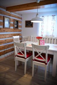 a dining room with a white table and two chairs at Górski Domek Nad Wodospadem in Jagniątków +33 photos