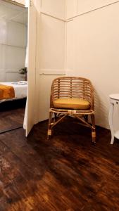 a rattan chair in a room with a bed at Rococo by Concordia Hospitality in Shillong +43 photos