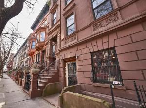 a pink brick building with stairs on the side of it at The Perfect Apt for Large Groups Sleeps 10 in New York