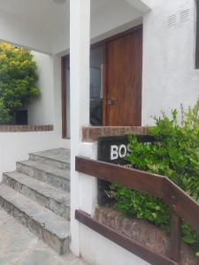 a house with a sign that says boo in front of a door at Pinamar para 5 a 100 metros del mar con garage in Pinamar