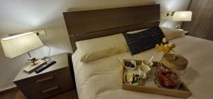 a hotel room with a bed with a tray of food at Ca' Piramidi Casa Vacanze in Postalesio +20 photos
