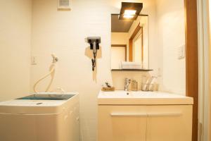 a bathroom with a sink and a phone on the wall at Hisaya-Totoya-A in Kyoto +30 photos