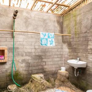 a bathroom with a sink and a shower and a sink at Pondok Inggris Homestay in Seganteng