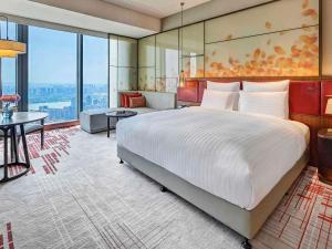 Voodi või voodid majutusasutuse Pullman Huizhou Kaisa toas