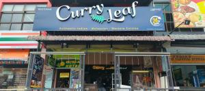 a sign for a curry tofu restaurant on a building at Clock Inn Backpackers Hostel in Tanah Rata