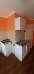 an empty kitchen with a sink and a stove at 2-Rent Group Hostel Apartments EVE74 in Munich +241 photos