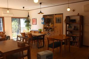 a dining room with wooden tables and chairs at そらやまゲストハウス Sorayama guesthouse in Ino