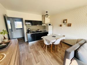 a kitchen and dining room with a table and chairs at Très bel appartement proche de la mer in Plestin-les-Grèves +20 photos
