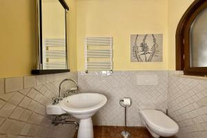 a bathroom with a sink and a toilet at Villa Isola Verde in Valsolda