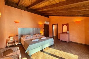 a bedroom with a large bed and a wooden ceiling at Villa Isola Verde in Valsolda +64 photos