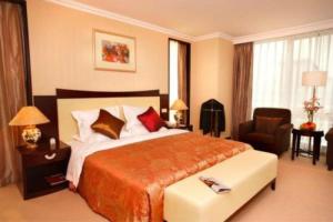 Ένα ή περισσότερα κρεβάτια σε δωμάτιο στο Jinjiang Fuyuan Hotel