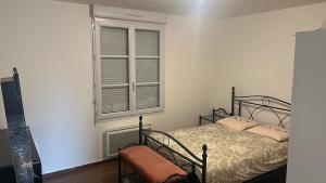 a bedroom with a bed and a window at Maison agréable de 51 m2 in Cuts