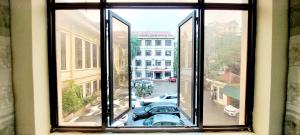 a window with a view of a parking lot at Viện Đào tạo, Bồi dưỡng Cán bộ và Nghiên cứu khoa học in Hanoi
