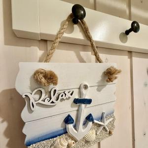 a nautical sign hanging on a kitchen cabinet at Meeresblume - Baabe in Baabe +19 photos