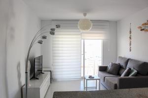 Telewizja i/lub zestaw kina domowego w obiekcie Apartamentos Esmeralda Unitursa