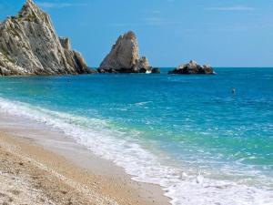 a beach with some rocks in the water at 2 or 4-person apartment CasaDaEfde in Cingoli