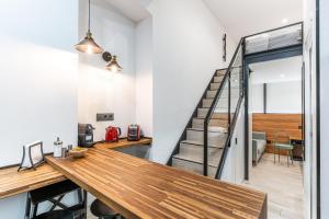 a room with a wooden table and a staircase at CC Atocha Apartments in Madrid