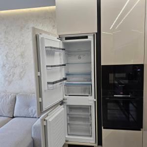 una nevera con la puerta abierta en una cocina en Арена Изгрев, en Burgas