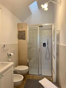 a bathroom with a shower with a toilet and a sink at Trulli San Pietro in Putignano +15 photos