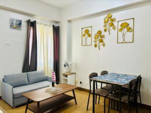 a living room with a couch and a table at Balauro's Haven in Trece Martires
