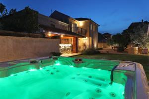 a hot tub in the backyard of a house at Villa Bonavita in Sukošan