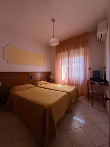 Postel nebo postele na pokoji v ubytování Grifone Hotel + 37 fotografií