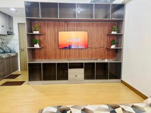 a living room with a flat screen tv on a wall at Balauro's Haven in Trece Martires