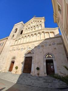 a church with a tall tower with stairs in front at Casa Dolce Paola in Cagliari +27 photos