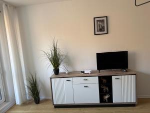 a living room with a tv on top of a cabinet at Apartament Nati in Cieszyn