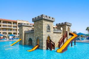 a water park with slides in front of a castle at Pickalbatros White Beach Resort - Hurghada in Hurghada