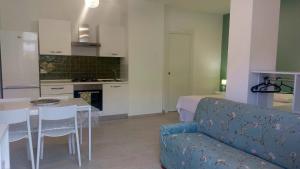 a kitchen and living room with a couch and a table at La Sanfelice in Agropoli