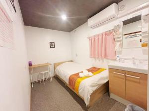 Postel nebo postele na pokoji v ubytování Hananosato Hotel 池袋本店