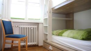 a bedroom with a bunk bed and a chair at Landhaus Büttner Altenberg in Kurort Altenberg