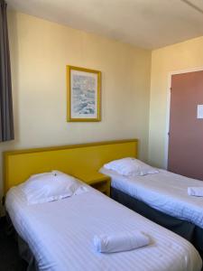 Postel nebo postele na pokoji v ubytování Hotel Le Bellevue
