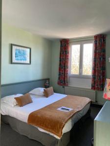 Postel nebo postele na pokoji v ubytování Hotel Le Bellevue
