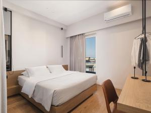 Postel nebo postele na pokoji v ubytování Theofilos City Hotel