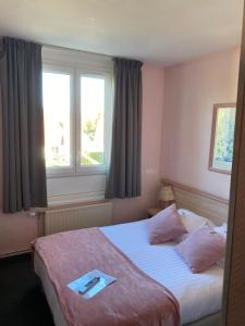 Postel nebo postele na pokoji v ubytování Hotel Le Bellevue