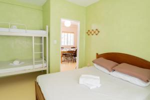 a bedroom with a bed and a dining room at Baroro Beach House LU in Bacnotan
