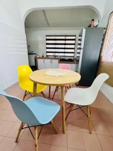 a yellow table and chairs in a kitchen at The Pine Lodge- Bukit Tinggi Klang in Klang +18 photos