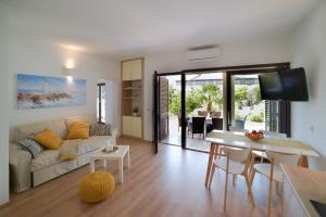 a living room with a couch and a table at Oasis Premium Twin in Primošten