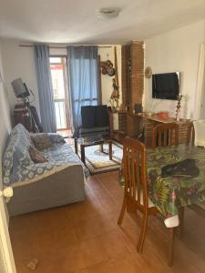 a living room with a couch and a dining room table at Wbs in Almería
