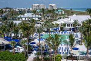 an aerial view of a resort with a pool and palm trees at Beachside Golf Villa in Fort Pierce