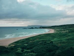 an aerial view of a beach and the ocean at Portrush Adelphi in Portrush