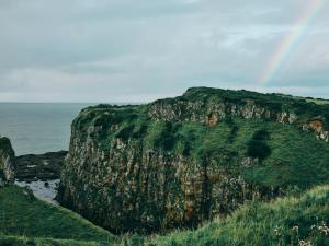 a large rocky cliff next to the ocean at Portrush Adelphi in Portrush