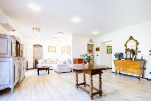 a living room with a table and a piano at Villa Rosa in Camogli