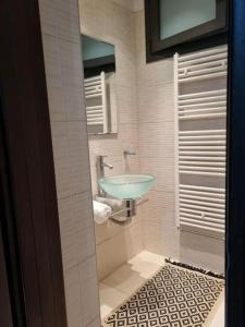 a bathroom with a sink and a mirror at Dimi Studio Image in Ierápetra