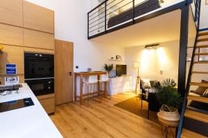a kitchen and living room with a loft at BudaVibe Apartman w AC by NW in Budapest +16 photos