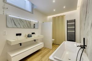 a white bathroom with a sink and a bath tub at Tra Vigna e Mare in Plan-de-la-Tour +115 photos